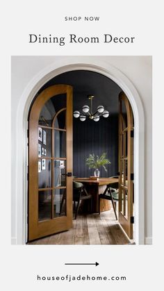 an open door leading to a dining room with wooden floors and black walls in the background