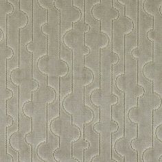 an upholstered beige fabric with wavy lines and circles on the top, as well as