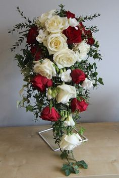 a bouquet of white and red flowers on a table