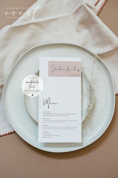 a white plate topped with a menu on top of a table