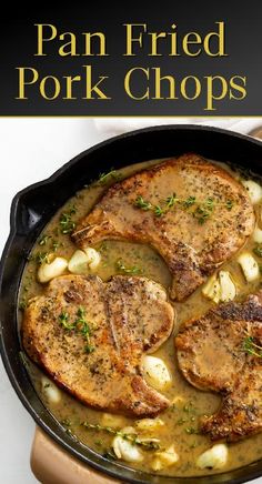 pork chops with potatoes and gravy in a cast iron skillet