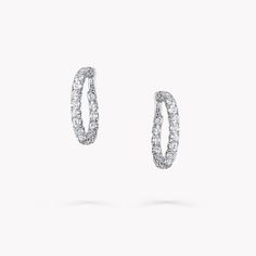 From the Classic Graff collection, our diamond hoop earrings in white gold are a twist on a timeless design. Cradled within a minimal white gold setting, each diamond radiates natural fire and exceptional brilliance. The Classic Graff collection features the finest Graff diamonds showcased in sleek, stylish silhouettes that you will wear time and time again. Available in a variety of different carat sizes. An elegant pair of Classic Graff round diamond hoop earrings with a total approximate weig Graff Jewelry, Carat Sizes, Graff Diamonds, White Gold Hoop Earrings, Round Diamond Earrings, Diamond Earrings Studs Round, White Gold Hoops, Simple Stud Earrings, Fine Diamond Jewelry