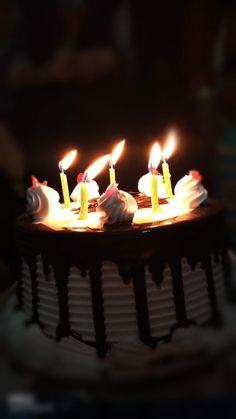 the birthday cake has lit candles on it