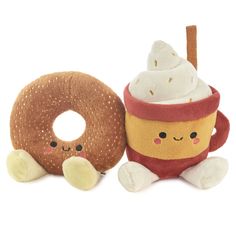 two stuffed animals sitting next to each other near a doughnut and donut toy