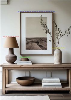 a wooden table with two vases on it and a lamp in front of it