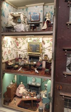 a doll house with lots of furniture and accessories in it's display case on the floor