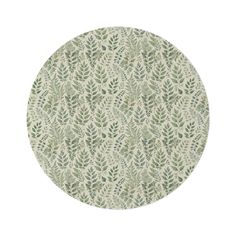 a round rug with green leaves on it