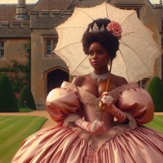 a woman in a pink dress holding an umbrella