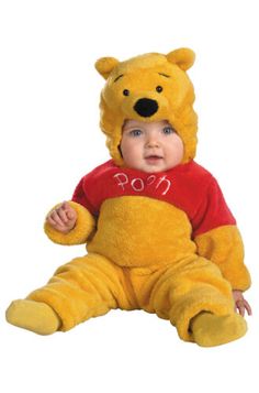 a baby wearing a winnie the pooh costume