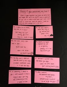 pink sticky notes are arranged on a black surface with words written on them and in cursive writing