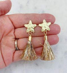 Beautiful star post earrings with a gold tinsel tassel measuring approximately 1.5-2". Perfect as shooting star earrings, 4th of July, Memorial Day, Labor Day, Veterans Day, or any patriotic event! Giftbox included Gold Tassel Earrings For Festive Occasions, Gift Tassel Drop Earrings With Fringe, Fringe Drop Tassel Earrings As Gift, Fringe Tassel Drop Earrings As Gift, Adjustable Gold Tassel Earrings For Party, Gold Dangle Tassel Earrings, Gold Dangle Tassel Earrings With Fringe, Gold Fringe Tassel Dangle Earrings, Adjustable Gold Tassel Earrings With Fringe