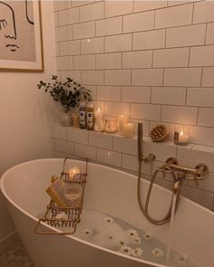 a bathtub filled with candles and flowers