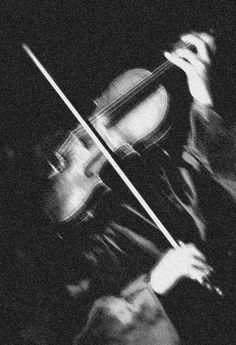 black and white photograph of a person playing the violin