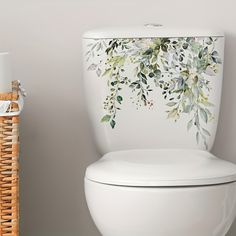 a white toilet sitting next to a wicker basket