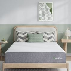 an image of a bed that is in the middle of a room with green walls