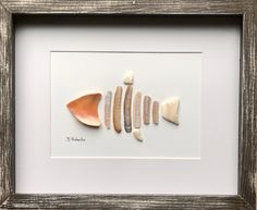 three seashells are arranged in a white frame