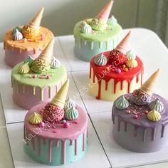 there are six cakes with different toppings on the top one is pink, green, blue and yellow