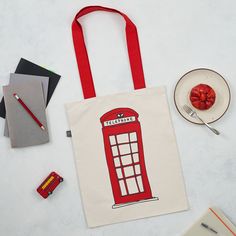 The Telephone Box & London Bus Canvas Bag / Tote iss part of the 'Simply London' Collection. Focusing on the nostalgic, whimsical view of London icons. This beautifully hand illustrated bag will remind you of everything you love about London. It's long handles are designed to make it ideal for carrying over your shoulder or in your hand and it is strong enough to fill with even the heaviest of items. Perfect for a serious shopping spree or a trip to the green grocers. Handmade in Britain, pr Eco-friendly Red Canvas Bag As Gift, Egg Mug, London Icons, Telephone Box, Interior Textiles, London Bus, China Mugs, Whimsical Illustration, Shopping Spree