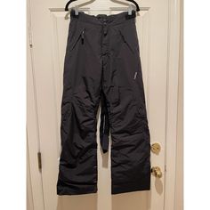 a pair of ski pants hanging on a door