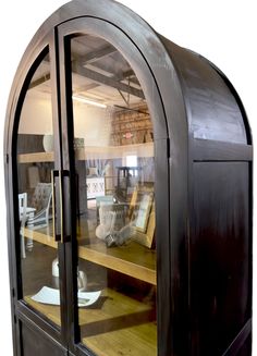 an arched glass display case with wooden shelves