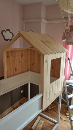 a child's play house made out of pallet wood