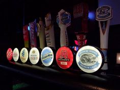 a row of beer taps sitting on top of a bar