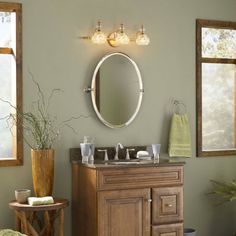 a bathroom with a sink, mirror and stool in it's centerpieces