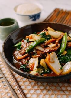 a bowl filled with stir fry vegetables on top of a table