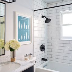 a bathroom with white tile and black fixtures