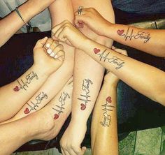 several people with tattoos on their arms and feet are sitting in a circle, holding each other's hands