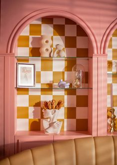 a living room filled with furniture and walls covered in checkerboard wall coverings