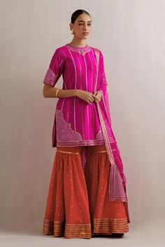 Magenta pink kurta with sequin, zari, aari embroidery in stripe pattern. Paired with red gharara and dupatta. - Aza Fashions Pink Palazzo Set With Dori Work, Bollywood Pink Palazzo Set With Gota Work, Eid Pink Sharara, Pink Gota Work Palazzo Set For Navratri, Pink Sharara With Dori Work, Bollywood Style Pink Palazzo Set With Pallu, Pink Palazzo Set With Gota Work For Festivals, Pink Palazzo Set With Dori Work For Navratri, Pink Traditional Drape Palazzo Set For Diwali