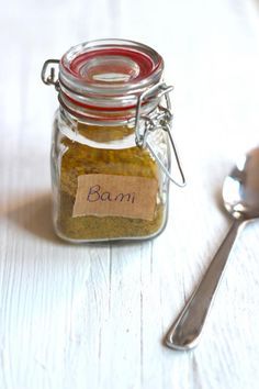 a jar filled with food next to a spoon