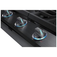 two burners on the side of a stove with blue light coming from one burner