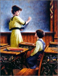 two children sitting at desks in front of a chalkboard