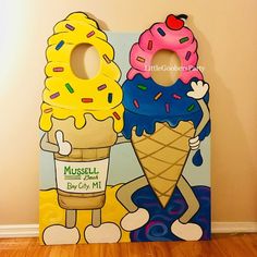 two ice cream cones with sprinkles on them are standing next to each other