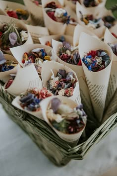 many different types of dried flowers in small baskets