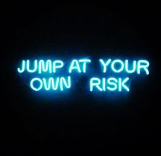 a neon sign that says jump at your own risk