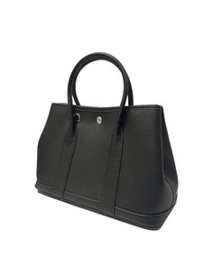 Steven Dann Small Leather Tote in black. Single compartment. Wall zipper pocket. Removable zipper pouch. Removable crossbody strap. Tonal stitching. Silver hardware. Snap closure. Classic Black Shoulder Bag With Palladium Hardware, Modern Black Satchel With Palladium Hardware, Black Satchel With Palladium Hardware For Office, Black Satchel With Palladium Hardware, Black Shoulder Bag With Palladium Hardware For Travel, Versatile Black Shoulder Bag With Gunmetal Hardware, Black Crossbody Shoulder Bag With Palladium Hardware, Everyday Black Satchel With Palladium Hardware, Black Crossbody Satchel With Palladium Hardware