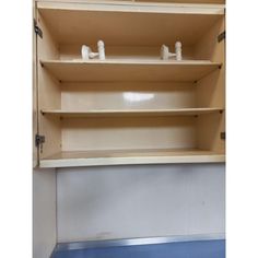 an empty shelf with two white faucets on each shelf and one blue floor