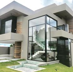 a modern house with glass walls and stairs