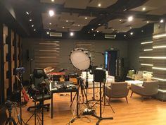 a recording studio with chairs, lights and equipment