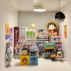 a room filled with toys and books on the floor next to a wall covered in posters