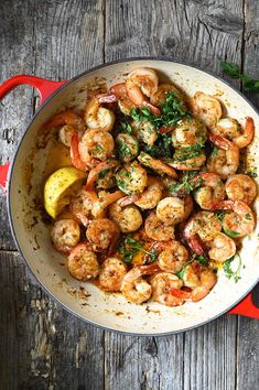 a skillet filled with shrimp and garnished with parsley