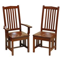 two wooden chairs sitting next to each other