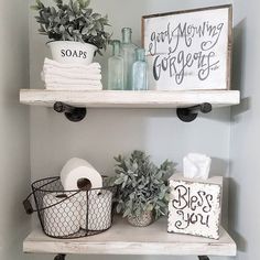 two shelves with toilet paper, plants and other bathroom items on top of each shelf