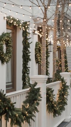 christmas garlands on the front porch of a house