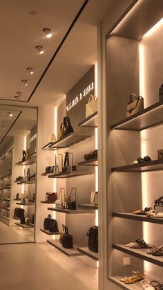 the inside of a shoe store with shelves full of shoes and handbags on display