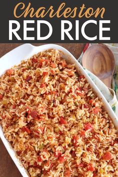 a white casserole dish filled with red rice and vegetables