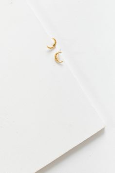 Textured crescent moon earring Post earring Gold plated Approximate measurement - 3/8" Gold Crescent Hoop Earrings With Moon Phase, Crescent Yellow Gold Brass Earrings, Crescent Shaped Yellow Gold Brass Earrings, Crescent-shaped Yellow Gold Brass Earrings, Half Moon Earrings With Moon Charm, Metal Half Moon Earrings With Moon Charm, Half Moon Metal Earrings With Moon Charm, Half-moon Metal Earrings With Moon Charm, Gold Crescent Cartilage Earrings Nickel Free